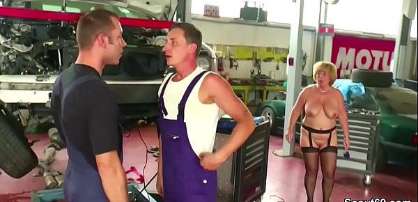  Two Young Seduce Big Tit German Milf to fuck in Workshop